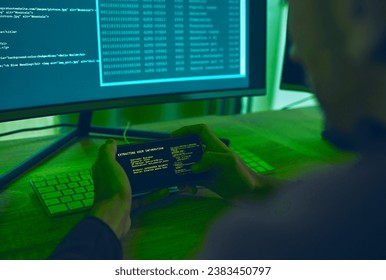 Computer hacker, coding and a man with phone for phishing, scam or cybersecurity software. Online crime, smartphone screen and cyber thief person with info for ransomware, hacking or malware script