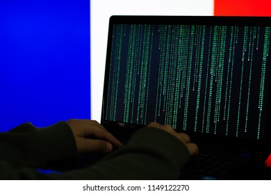 Computer Hacker in front of flag