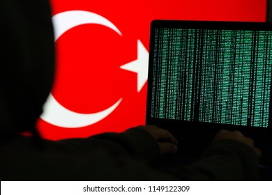 Computer Hacker in front of flag
