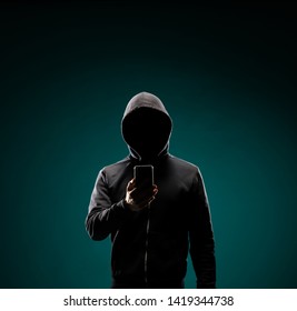 Computer Hacker In Hoodie. Obscured Dark Face. Data Thief, Internet Fraud, Darknet And Cyber Security Concept.
