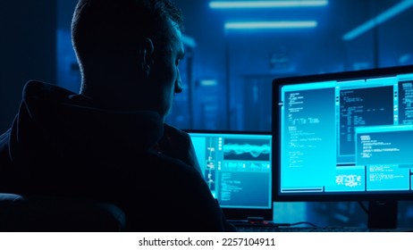 Computer Hacker in Hoodie. Obscured Dark Face. Concept of Hacker Attack, Virus Infected Software, Dark Web and Cyber Security. - Shutterstock ID 2257104911