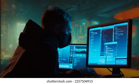 Computer Hacker in Hoodie. Obscured Dark Face. Concept of Hacker Attack, Virus Infected Software, Dark Web and Cyber Security. - Shutterstock ID 2257104913