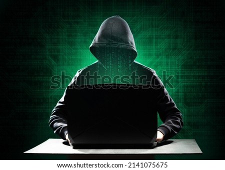 Computer Hacker in Hoodie. Obscured Dark Face. Hacker Attack, Virus Infected Software, Dark Web and Cyber Security Concept .