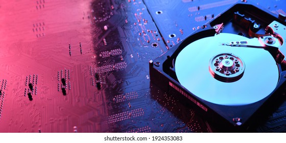 Computer Hard disk drives HDD , SSD on circuit board ,motherboard background. Close-up. With red-blue lighting. - Shutterstock ID 1924353083