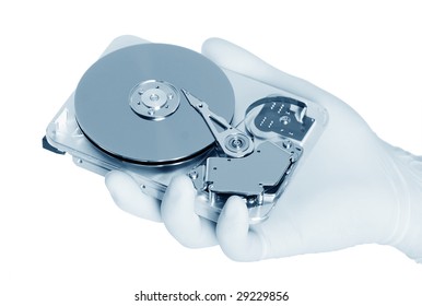 Computer hard disk holds a white gloved hand