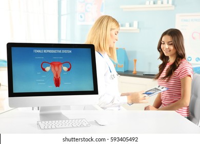 Computer at hospital on blurred gynecologist and woman background