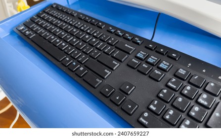 computer keyboard with backlight, on a modern desk