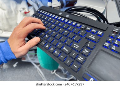 computer keyboard with backlight, on a modern desk