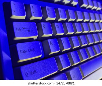 Computer keyboard in blue light. 