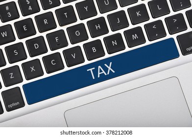 The computer keyboard button written word tax .