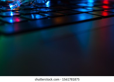 Computer keyboard close up with colorful backlight soft focus