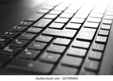 Computer keyboard close-up, black and white photography.