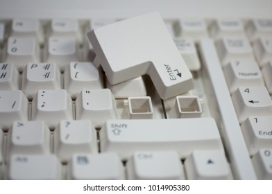 Computer keyboard with 'ENTER' key detached.