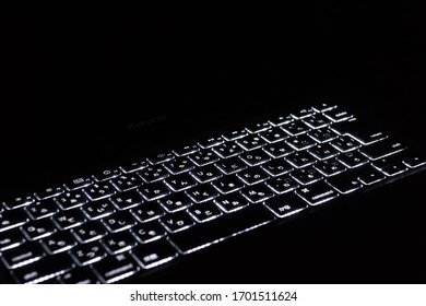 Computer keyboard glowing in the dark
