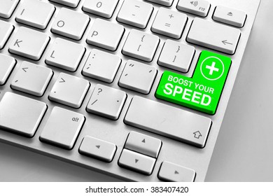 Computer keyboard with green boost your speed button 