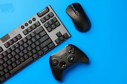 Computer Keyboard And Joystick On Blue Background Top View