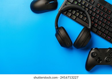 Computer keyboard and joystick on blue background top view - Powered by Shutterstock