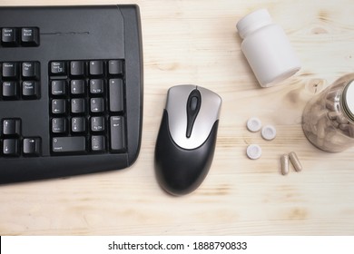 Computer Keyboard, Mouse And Bottles Of Mental Support Supplement Capsules. Chewing Gum For Neuro Boost. Vitamins And L-theanine For Nootropic Effect. E-sport And Gaming Enhancers. 