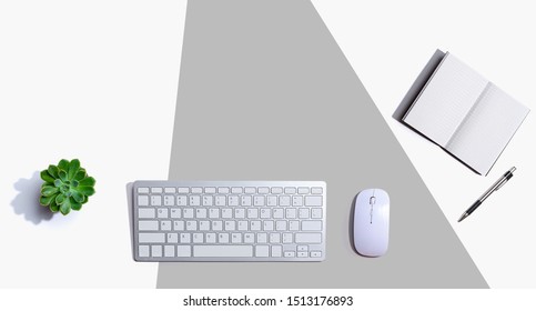 Computer keyboard and mouse with notebook from above