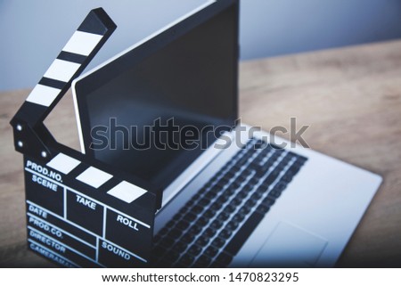 computer keyboard with movie sign on the wooden desk