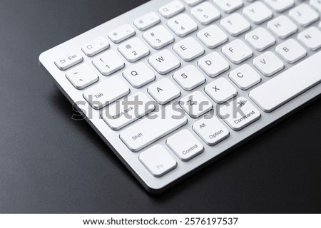 Computer keyboard on a black background.