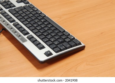 Computer keyboard on a wooden table