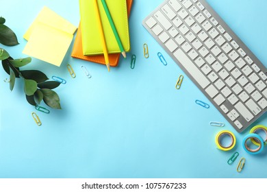 Computer Keyboard And Stationery On Color Background, Flat Lay. Workplace Table Composition