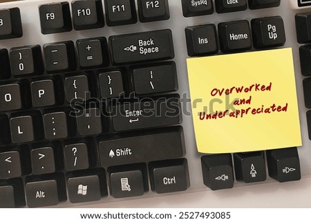 Computer keyboard with stick note written OVERWORKED and UNDERAPPRECIATED - Feeling undervalued at work or feel like your efforts go unnoticed