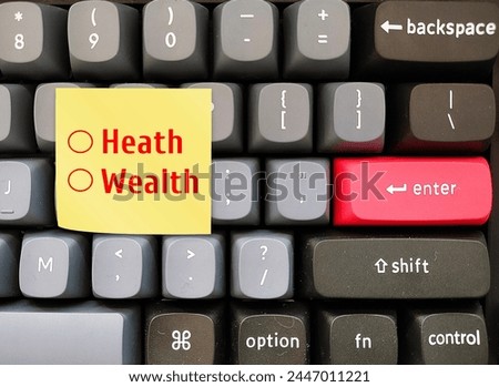 Computer keyboard with text written note WEALTH or HEALTH  - Concept of work life balance - decision making to choose between health happiness or financial success