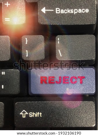 Computer keyboard.  There are various letters and numbers and including the Reject button. Also have flare on the left side. Selective focus. Had a little big nose some area.