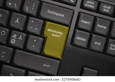 Computer keyboard with a yellow absolutely sure button.