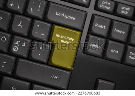 Computer keyboard with a yellow absolutely sure button.