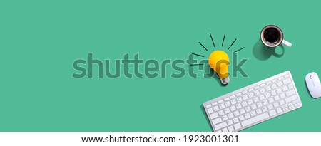 Computer keyboard with a yellow light bulb from above