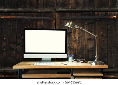 Computer and lamp table on wood desk