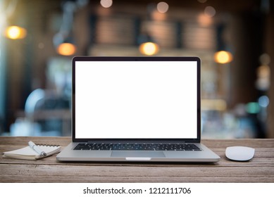 Computer Laptop with blank screen on  table of coffee shop blur background with bokeh, desk  blank work office mockup monitor