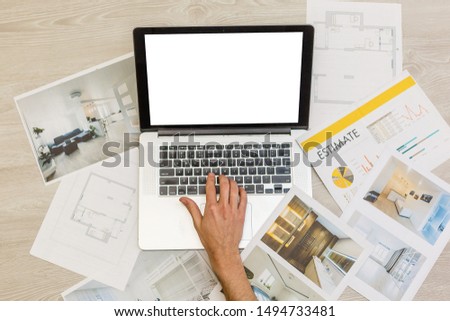 computer laptop on architectural drawing paper for construction white