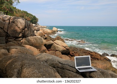 Computer laptop on the beach