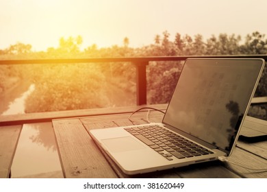 Computer Laptop On Table In Garden Ready To Work. Vintage Filter