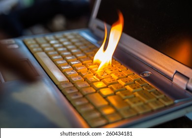Computer laptop sleeve is on fire. Means love burns up the internet to set the world on fire damaged computers, insurance claims, etc. Hell. - Shutterstock ID 260434181