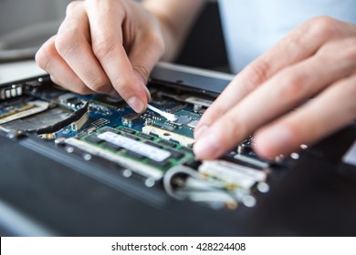 Computer literacy repair men hands, man examines laptop clean thermal paste - Powered by Shutterstock