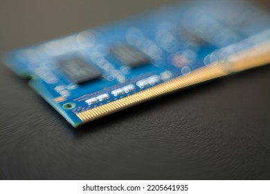 Computer memory chip placed on top of a black table. Connections and circuits on display. Chip concept. Technology concept.