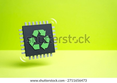 A computer microchip with a recycling symbol. The problem of electronics recycling. E-waste growth and tech sustainability challenges. Environmental reports and circular economy.