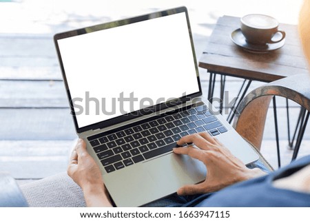 computer mockup image blank screen with white background for advertising text,hand woman using laptop contact business search information on desk at coffee shop.marketing and creative design