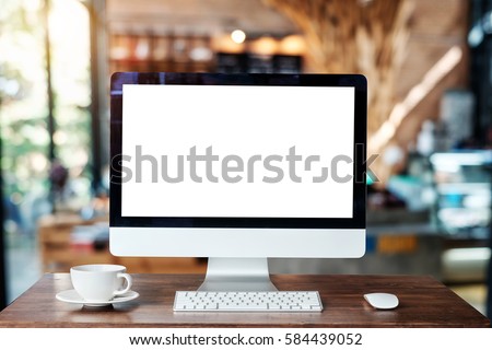 Computer Monitor, Keyboard, coffee cup and Mouse with Blank or White Screen Isolated is on the work table in the coffeeshop 
