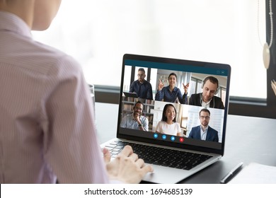 Computer Monitor View Over Female Shoulder During Group Video Call With Multi-ethnic International Colleagues Or Friends. Distant Communication And Working Use On-line App, Internet Connection Concept