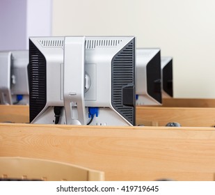 Computer Monitors Arranged In Row At Classroom