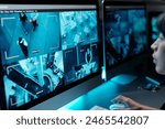 Computer monitors with cctv video on screens standing on workplace of security guard observing situations on every floor of modern hotel