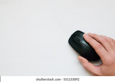 The Computer Mouse In Hand On A White Background