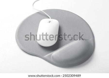 Computer mouse and mousepad with armrest on white table