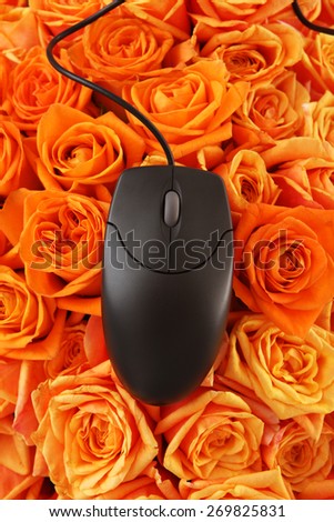 Computer mouse on roses